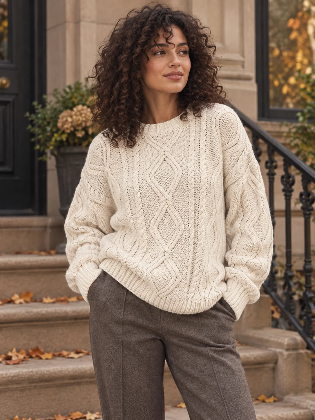Woman wearing an ivory cable-knit crew neck sweater — Alfa Empire Sweaters