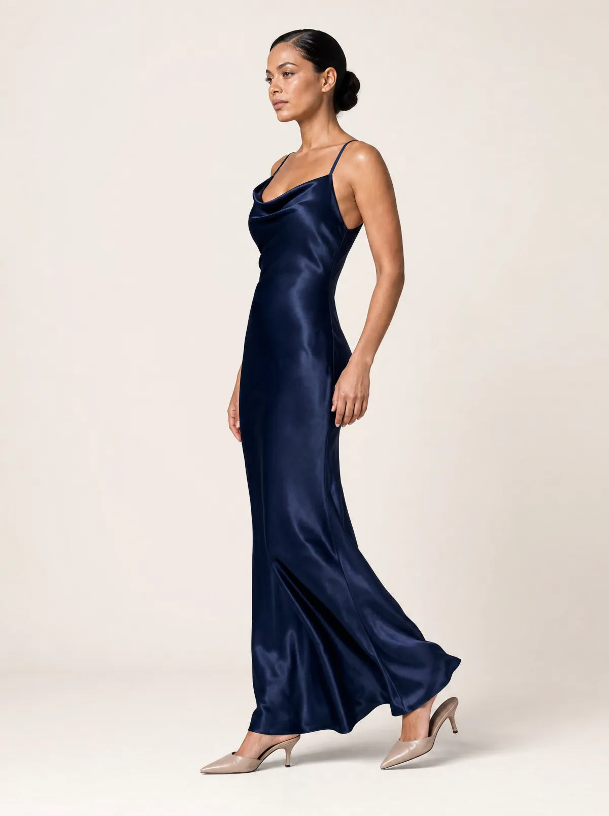 Elodie midnight navy satin maxi dress in a side-profile walking view