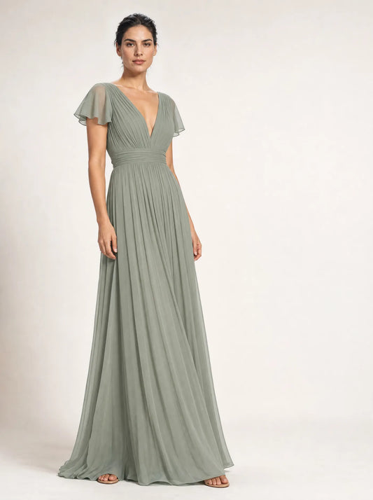 Woman wearing the sage Liora pleated flutter-sleeve maxi dress against an off-white studio background