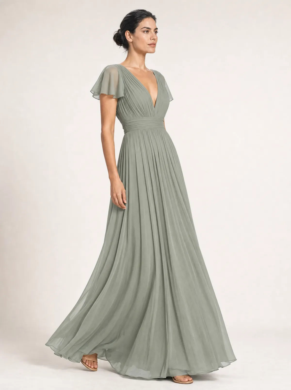 Liora sage pleated maxi dress in a side-profile walking view