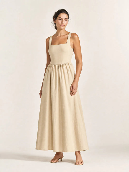 Woman wearing the sand Maren gathered square-neck maxi dress against a warm white studio background