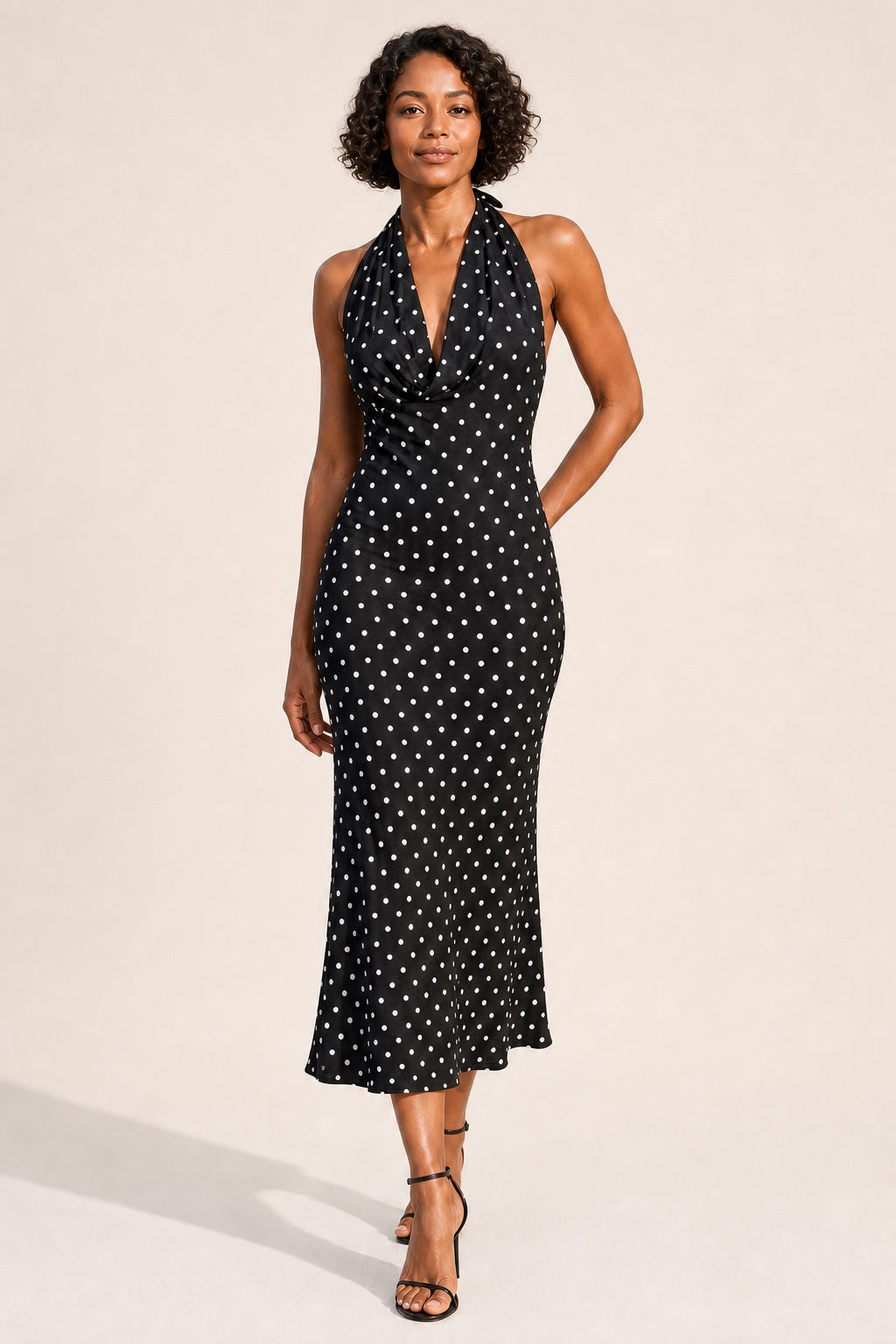 Ruby polka-dot halter midi dress in black - confident front view